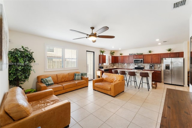 living room with a ceiling fan, light tile patterned flooring, recessed lighting, and visible vents