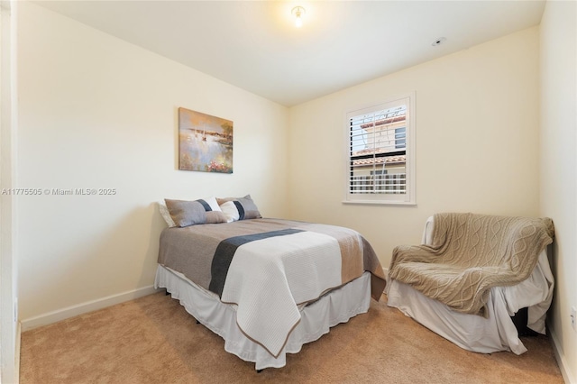 bedroom featuring baseboards and light carpet