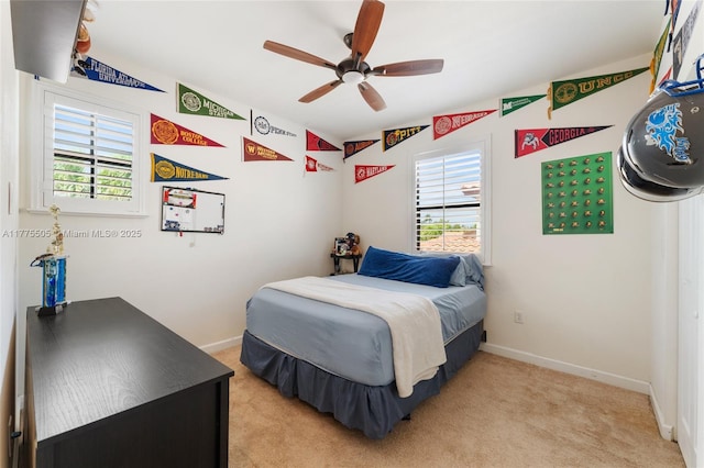 bedroom featuring a ceiling fan, baseboards, and light colored carpet