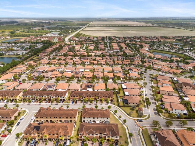 drone / aerial view featuring a residential view and a water view