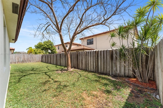 view of yard with a fenced backyard