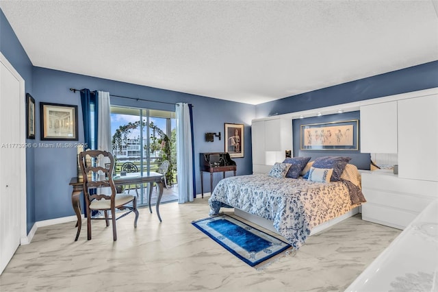 bedroom with marble finish floor, baseboards, a textured ceiling, and access to exterior