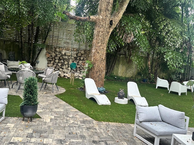view of patio / terrace with an outdoor hangout area and fence