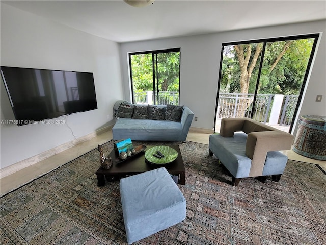 living area featuring baseboards