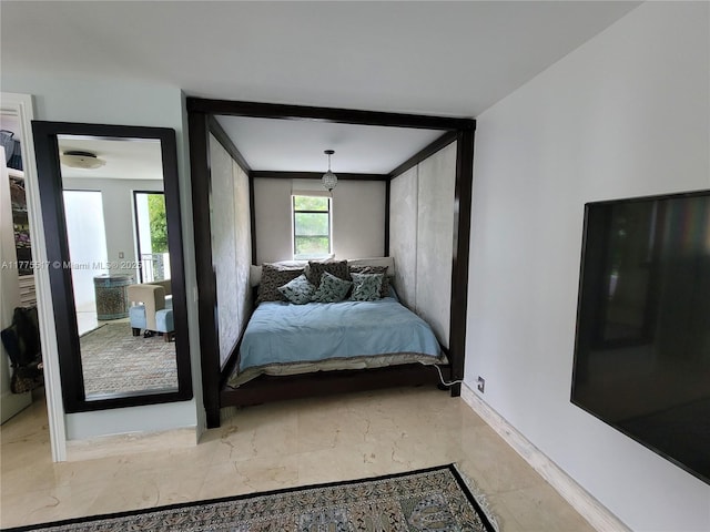 bedroom with marble finish floor and baseboards