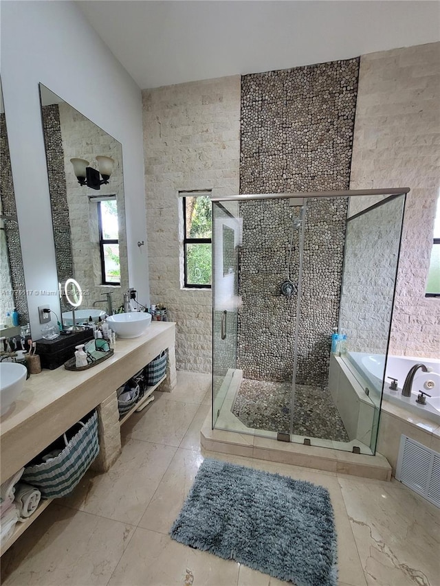 bathroom featuring a shower stall, visible vents, a sink, and a garden tub