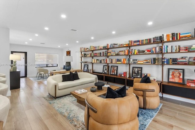living area featuring visible vents, wood finished floors, and recessed lighting