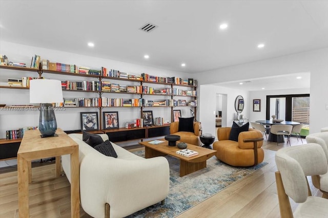sitting room with recessed lighting, wood finished floors, and visible vents