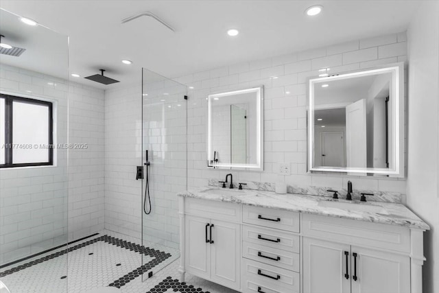 bathroom featuring recessed lighting, a shower stall, and a sink