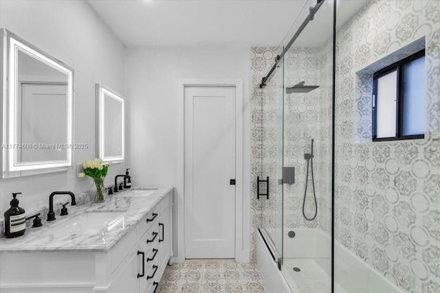 full bathroom featuring tile patterned flooring, bath / shower combo with glass door, a sink, and double vanity
