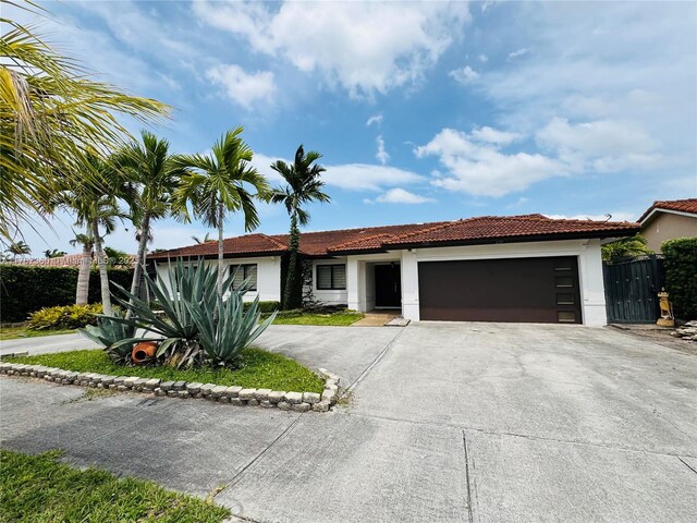 20785 SW 129th Ct, Miami, FL 33177 - ranch-style house featuring stucco siding, an attached garage, driveway, and a tiled roof
