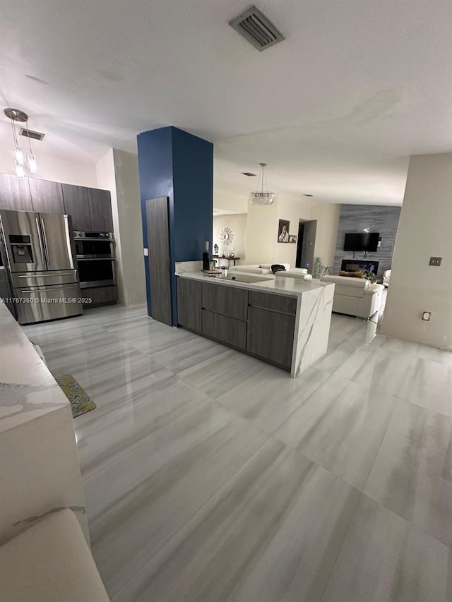 kitchen with stainless steel appliances, visible vents, modern cabinets, and light countertops