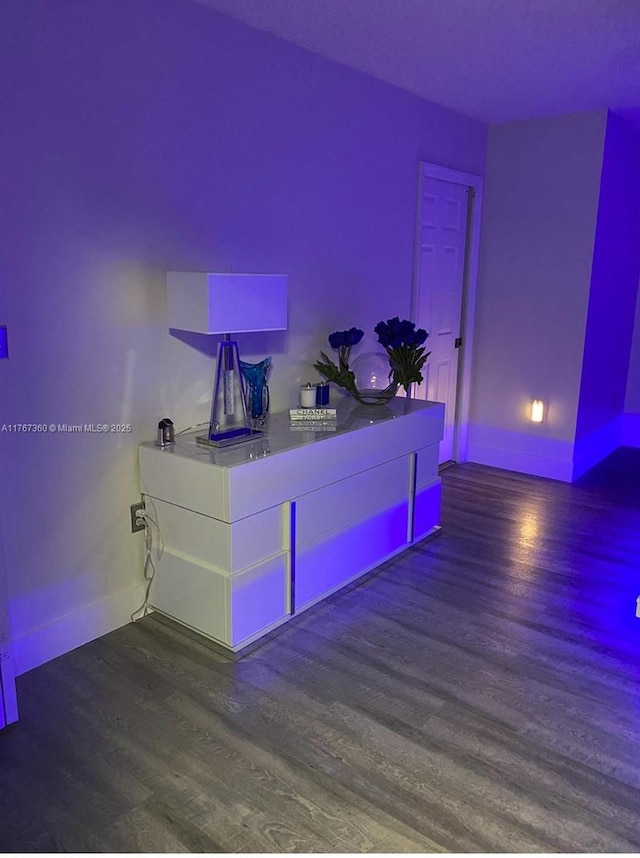 interior space with baseboards and wood finished floors