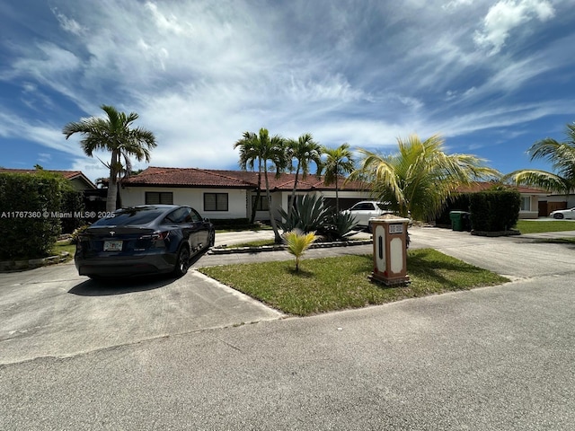 view of front of house with concrete driveway and stucco siding