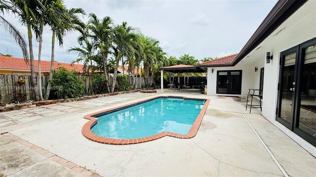 20785 SW 129th Ct, Miami, FL 33177 - view of swimming pool with a patio area, a fenced backyard, and a gazebo