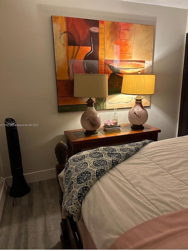 bedroom featuring baseboards and wood finished floors