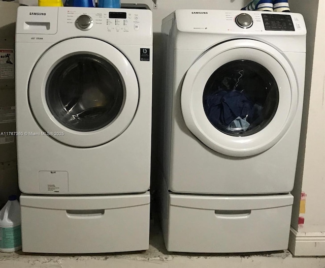 washroom with separate washer and dryer and laundry area