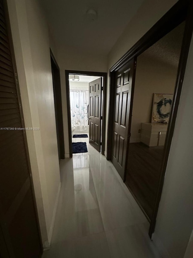 hall featuring baseboards