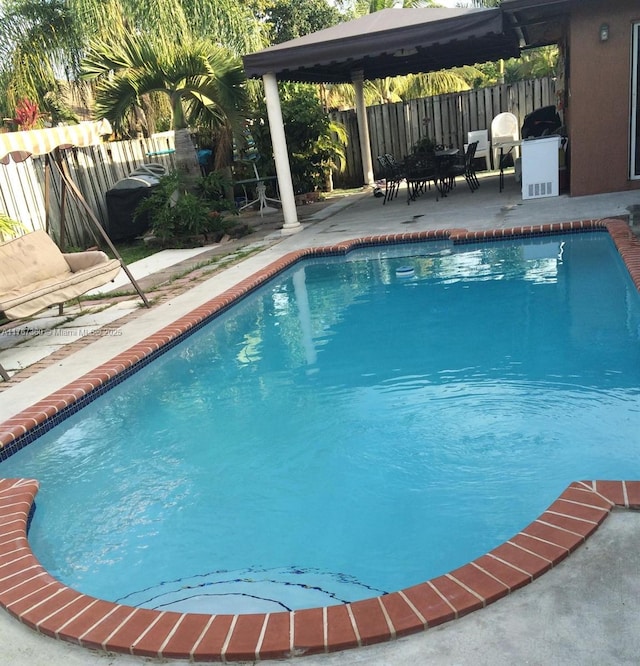 view of pool with a patio area, fence, and a fenced in pool