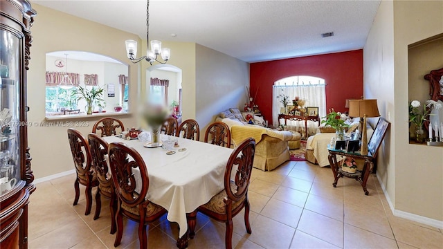 dining room with baseboards, a chandelier, tile patterned flooring, and visible vents