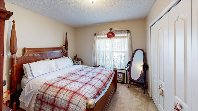 bedroom featuring light colored carpet, a closet, and a textured ceiling