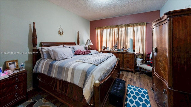 bedroom featuring dark wood-style flooring and a textured ceiling