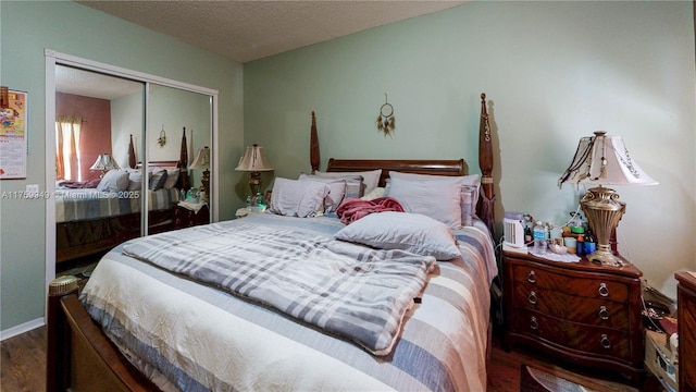 bedroom featuring a closet, a textured ceiling, and wood finished floors