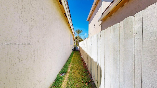 view of home's exterior featuring fence and stucco siding