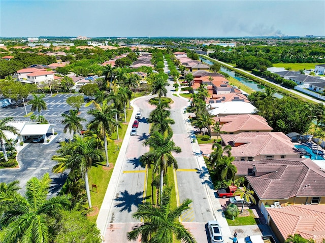 birds eye view of property featuring a water view and a residential view