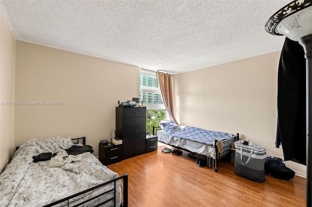 1035 W Ave Unit 507, Miami Beach, FL 33139 - bedroom featuring a textured ceiling and light wood-style flooring