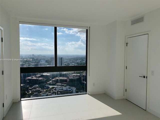 empty room with a city view and visible vents