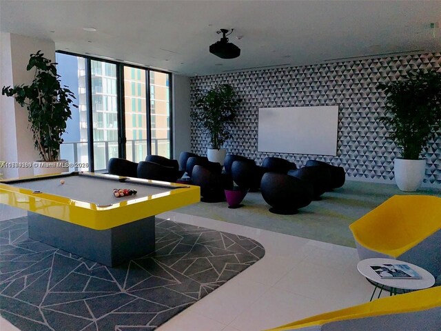 game room featuring tile patterned floors, floor to ceiling windows, and pool table