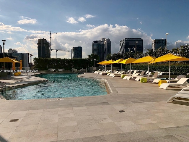 pool with a city view and a patio area