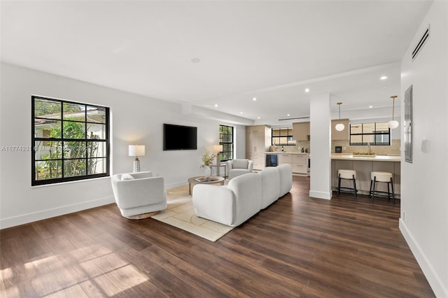 living room featuring visible vents, recessed lighting, and dark wood-type flooring