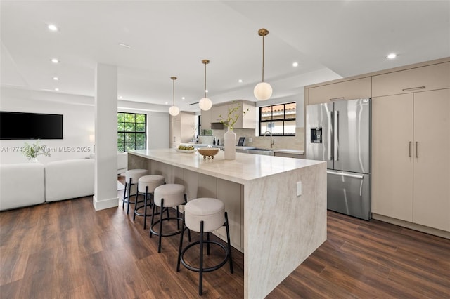 kitchen featuring modern cabinets, recessed lighting, a spacious island, and stainless steel fridge with ice dispenser