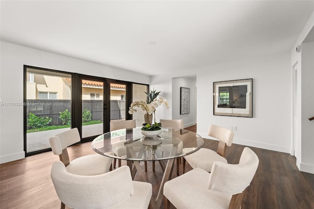 dining area featuring french doors, wood finished floors, and baseboards