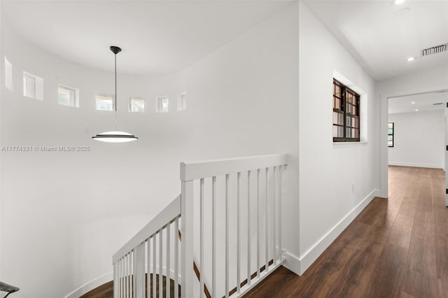 hall featuring baseboards, visible vents, recessed lighting, an upstairs landing, and wood finished floors