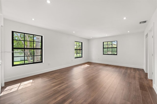 unfurnished bedroom featuring recessed lighting, baseboards, visible vents, and dark wood-type flooring