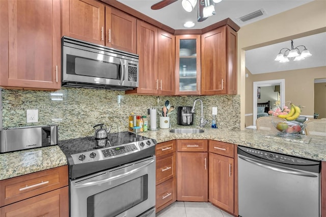 2343 SW 15th Pl, Deerfield Beach, FL 33442 - kitchen featuring visible vents, light stone countertops, appliances with stainless steel finishes, a sink, and backsplash