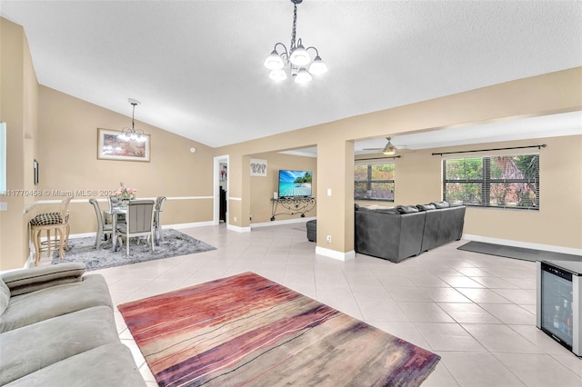 2343 SW 15th Pl, Deerfield Beach, FL 33442 - living room with ceiling fan with notable chandelier, light tile patterned floors, baseboards, and lofted ceiling