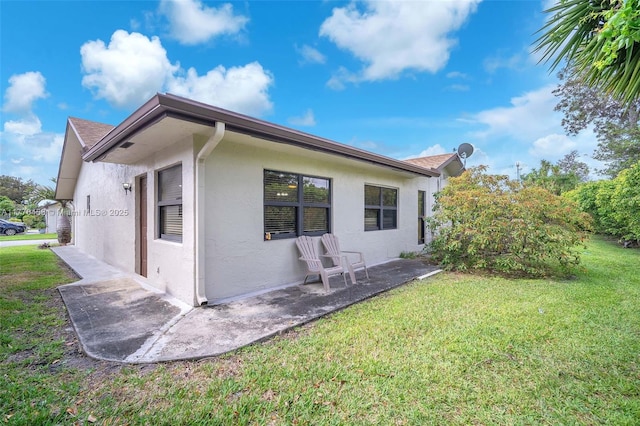 2343 SW 15th Pl, Deerfield Beach, FL 33442 - rear view of house featuring stucco siding, a patio, and a yard
