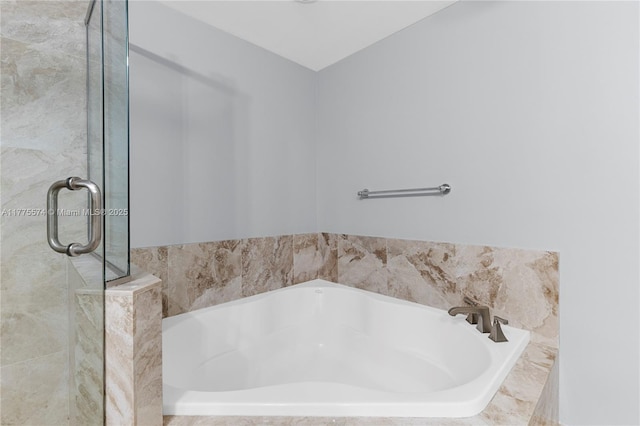 full bath with a bath and a shower stall