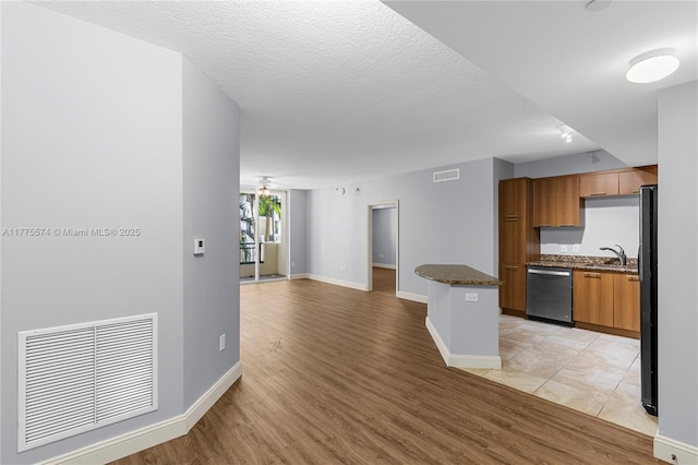 510 NW 84th Ave Unit 242, Plantation, FL 33324 - kitchen with dishwasher, brown cabinets, light wood-type flooring, freestanding refrigerator, and open floor plan