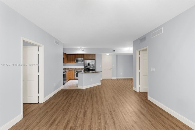 510 NW 84th Ave Unit 242, Plantation, FL 33324 - unfurnished living room with light wood finished floors and baseboards