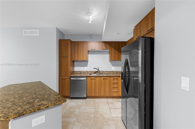 510 NW 84th Ave Unit 242, Plantation, FL 33324 - kitchen featuring stainless steel dishwasher, black fridge with ice dispenser, a sink, and brown cabinets
