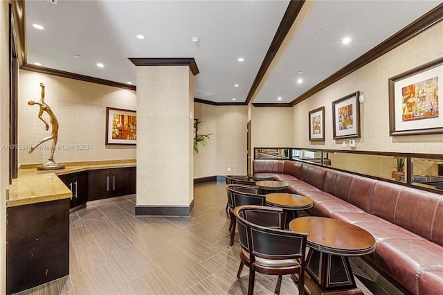 lobby featuring crown molding, recessed lighting, and wallpapered walls