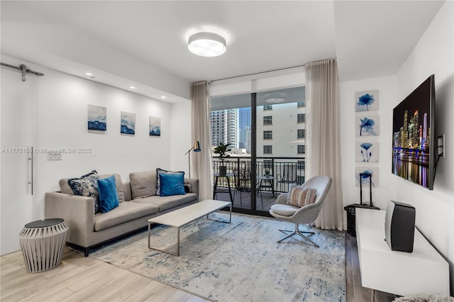 living area with floor to ceiling windows and wood finished floors
