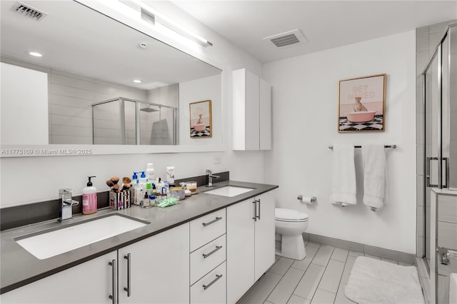 full bath with visible vents, a sink, and a stall shower