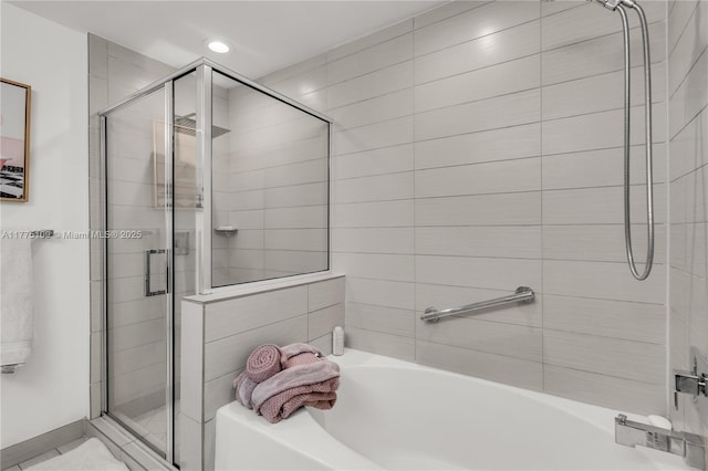 full bathroom featuring a stall shower and a bath