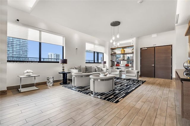 living area with visible vents and light wood-style floors